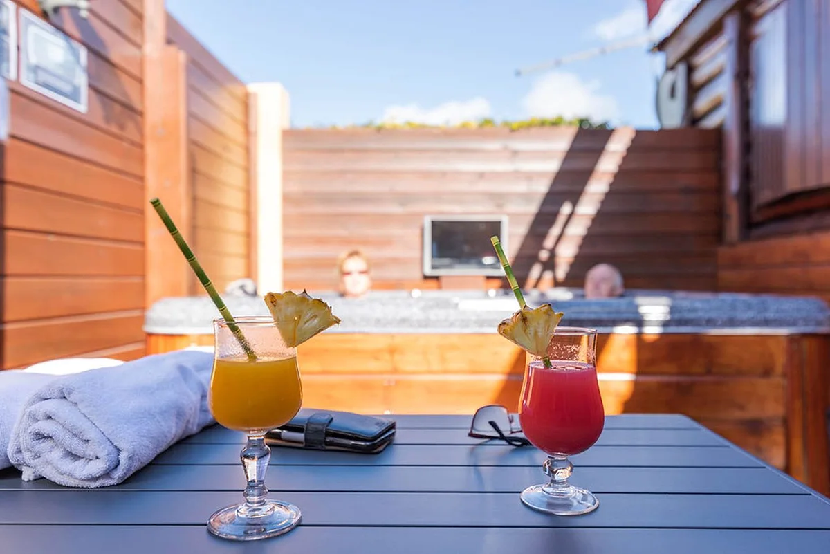 Deux cocktails servis sur la table, au bord du jacuzzi